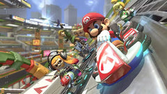 Cartoon characters in racing carts on a track with a cityscape background